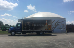 Delivery Truck in front of Guinness' signature at Guinness Open Gate Brewery and Barrel House